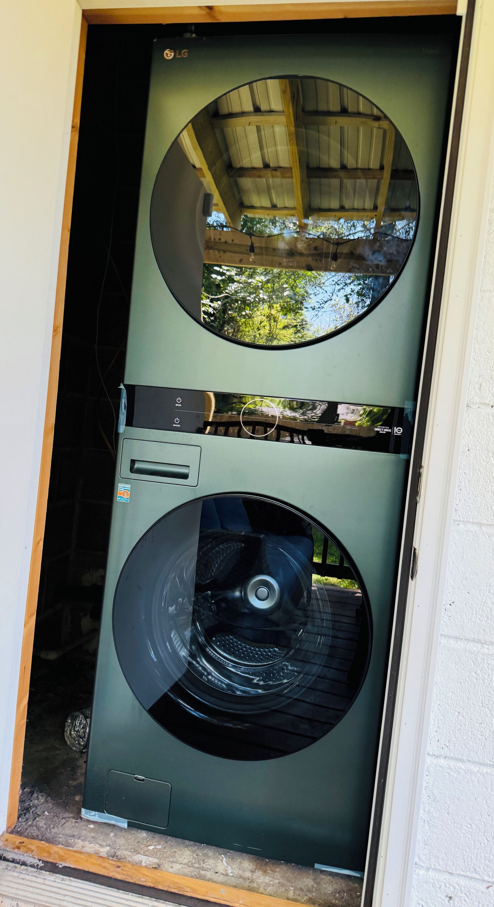 A door with a circular window and a washing machine inside.