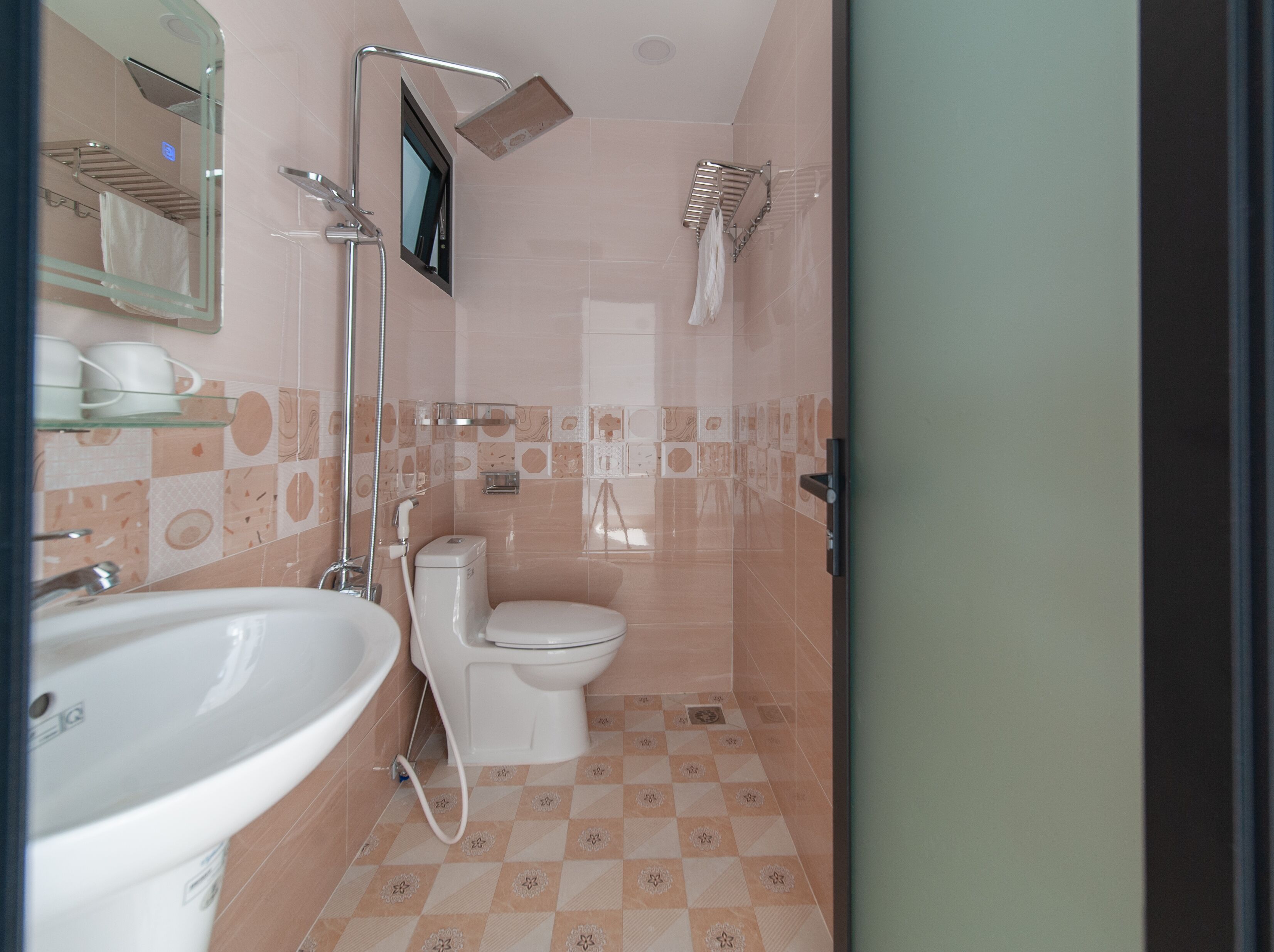 A bathroom with a sink, toilet, and shower.