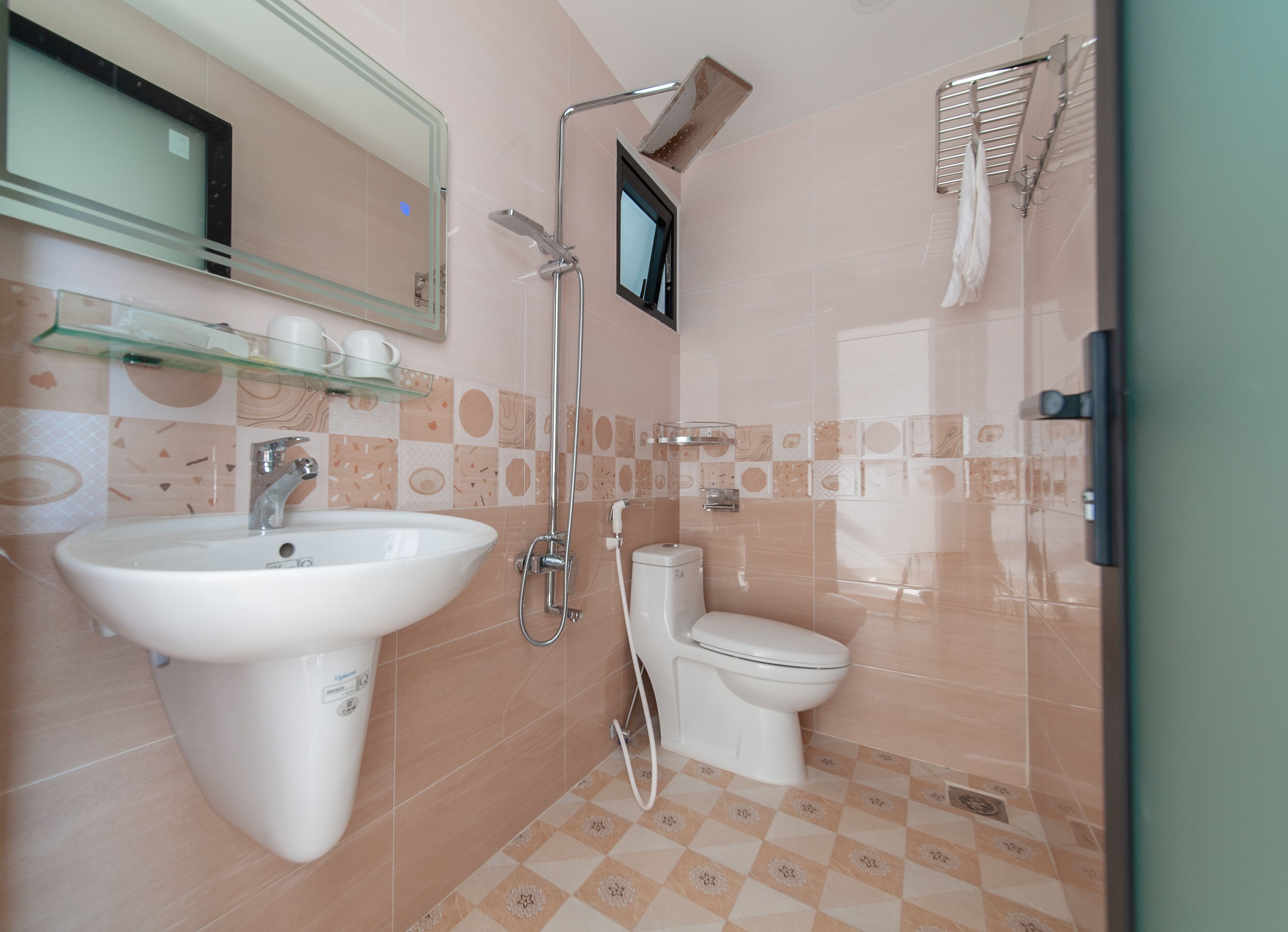 A bathroom with a sink, toilet, and shower.