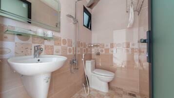 A bathroom with a sink, toilet, and shower.