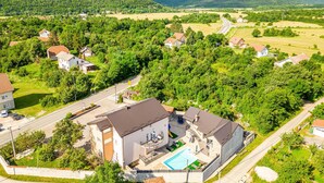 A residential area with houses, a swimming pool, and a road. - Amazing apartment in Gracac (Gracac)