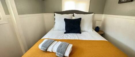 1 bedroom, desk, iron/ironing board, travel crib