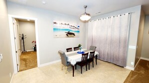 A dining area with a table set for four, a ceiling fan, and a painting of a turtle on the wall. - NEW! Luxury Modern Retreat House in Flagstaff (Flagstaff)