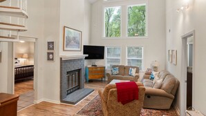 A spacious living room with a fireplace, a comfortable sofa, and a television. - Relax in a Pet-Friendly Lowcountry Home Near Beaches, Downtown Beaufort, and USMC Graduation! (Beaufort)