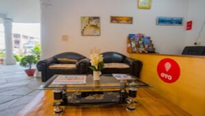 A reception area with a sofa, a coffee table, and a reception desk. - Merostay 019 Hotel Bien Venue (Pokhara)