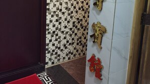 A hotel entrance with a sign indicating 'Spain House' and a red mat with gold characters. - spanish hostel (Kowloon)