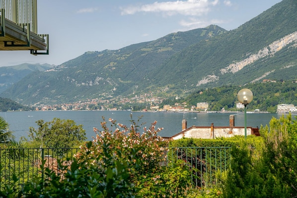 A coastal view with mountains, a body of water, and a small town.