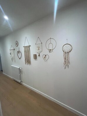 A gallery with various wall-mounted art pieces.