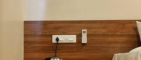A wooden headboard with a built-in kettle and a control panel.