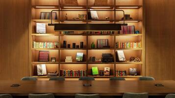 A well-lit wooden bookshelf with books and decorative items, a conference table with chairs, and a modern design.