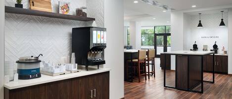 A modern kitchen with a herringbone tile backsplash, a coffee machine, and a wooden cutting board.