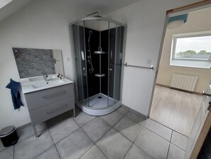 Shower, hair dryer, towels, toilet paper