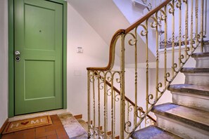 A green door with a doorknob and a mat with 'WELCOME' written on it.
