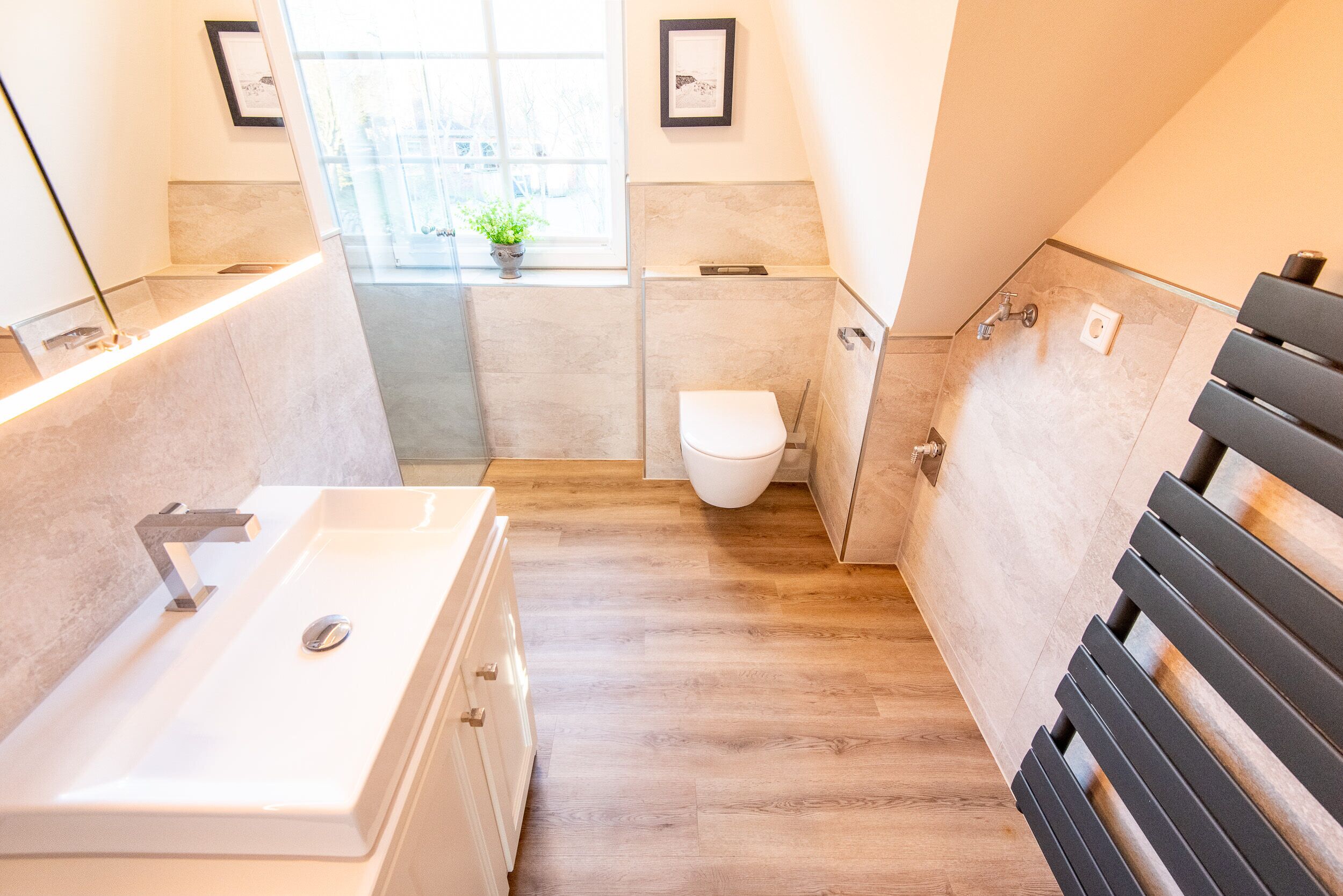 A modern bathroom with a bathtub, toilet, and shower.
