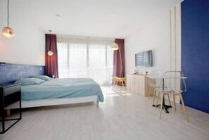 Relax in a stylish room with a comfortable bed, desk, and flat-screen TV.