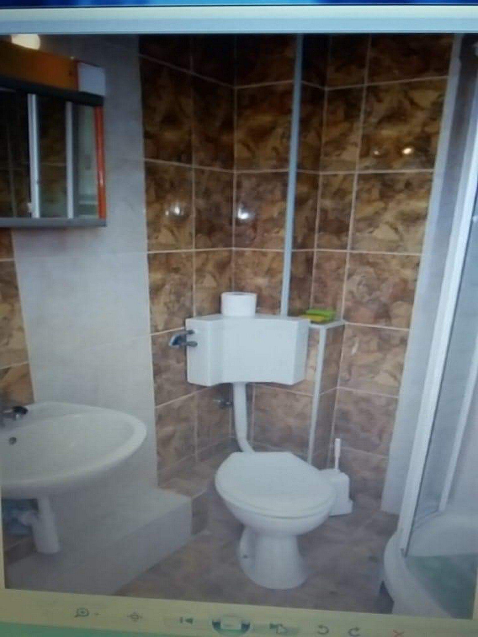 A bathroom with a toilet, bidet, and sink.