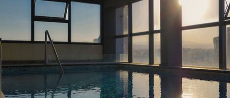 Indoor pool, outdoor pool, open 10:00 AM to 11:00 AM, pool umbrellas