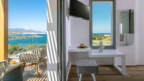 A modern room with a large window offering a view of the sea and mountains. - Villa Anemos Heated pool (Agios Nikolaos)