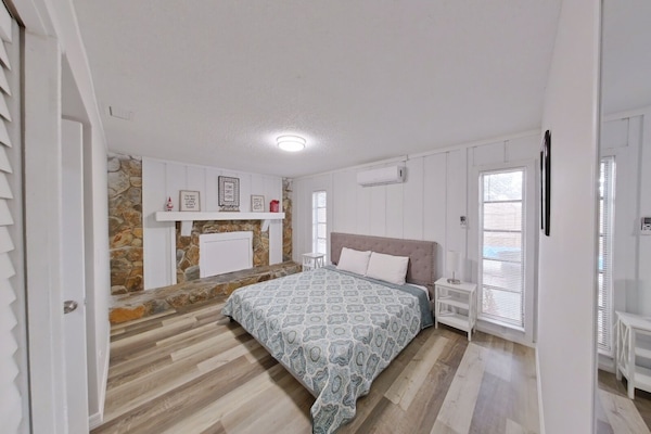 Bedroom with king size bed and an AC: split type ductless system