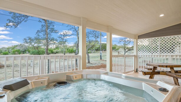A hot tub with a view of a dry landscape and trees. - Private Hot Tub - Fireplace - 4 min. to downtown - Wildlife (Fredericksburg)