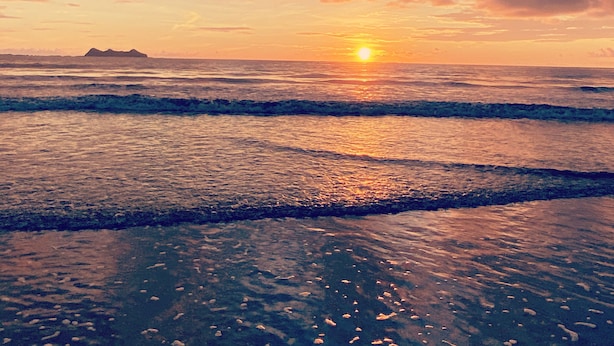 A sunset over the ocean with waves and a distant island. - Casa Arenas, steps away from the ocean! (Provincia de Puntarenas)