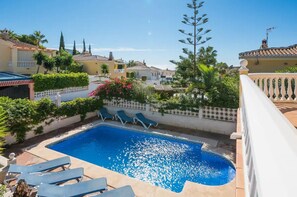 A swimming pool with lounge chairs, surrounded by greenery and buildings. - 43813- 3 bedroom- Beautiful accommodation with private pool (velez malaga)