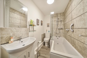 Combined shower/bathtub, deep-soaking bathtub, hair dryer, towels