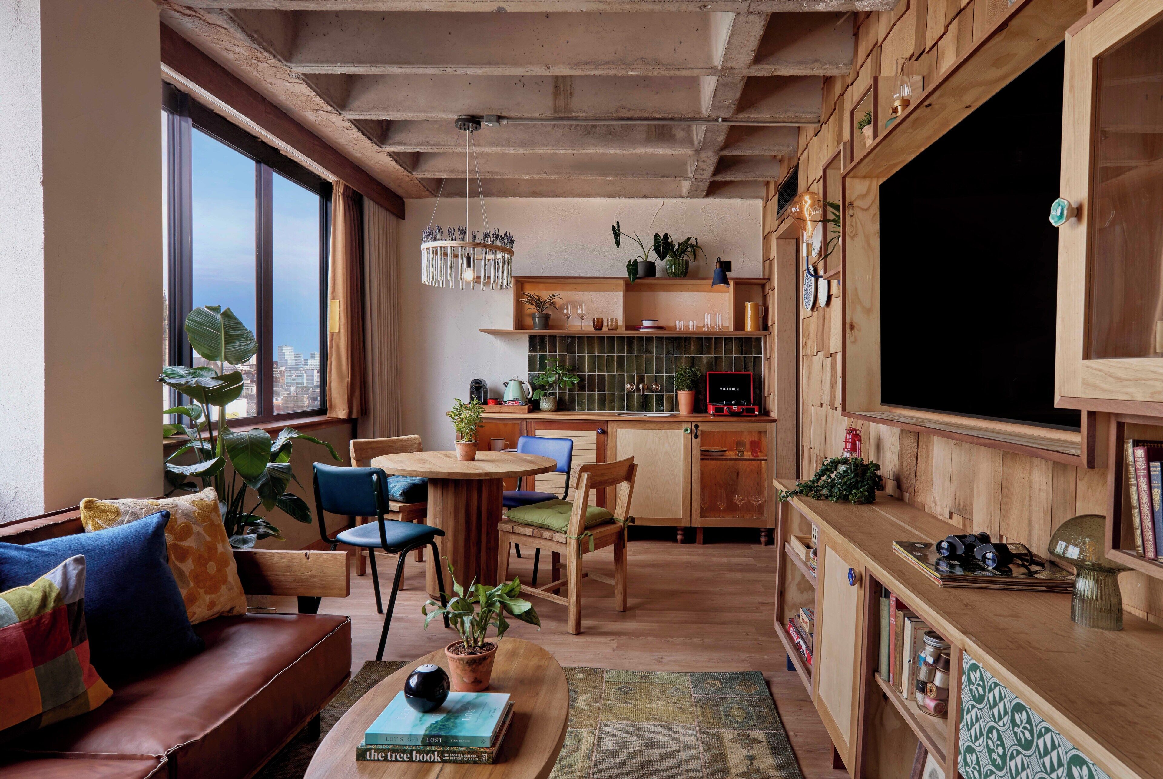 A cozy living room with a sofa, chairs, a coffee table, and a fireplace.