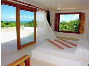 Enjoy a peaceful retreat with a view of lush green surroundings from the large window.