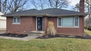 A single-story brick house with a dark roof, a front door, and two windows on the side. - Location. Location. Location. Only 15 minute walk to Mackey Arena. (West Lafayette)