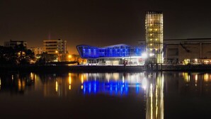 A modern building with a unique curved roof, reflecting on the water. - L'Aparté ★ HYPER CENTRE ★ LUMINEUX ★ (Lorient)
