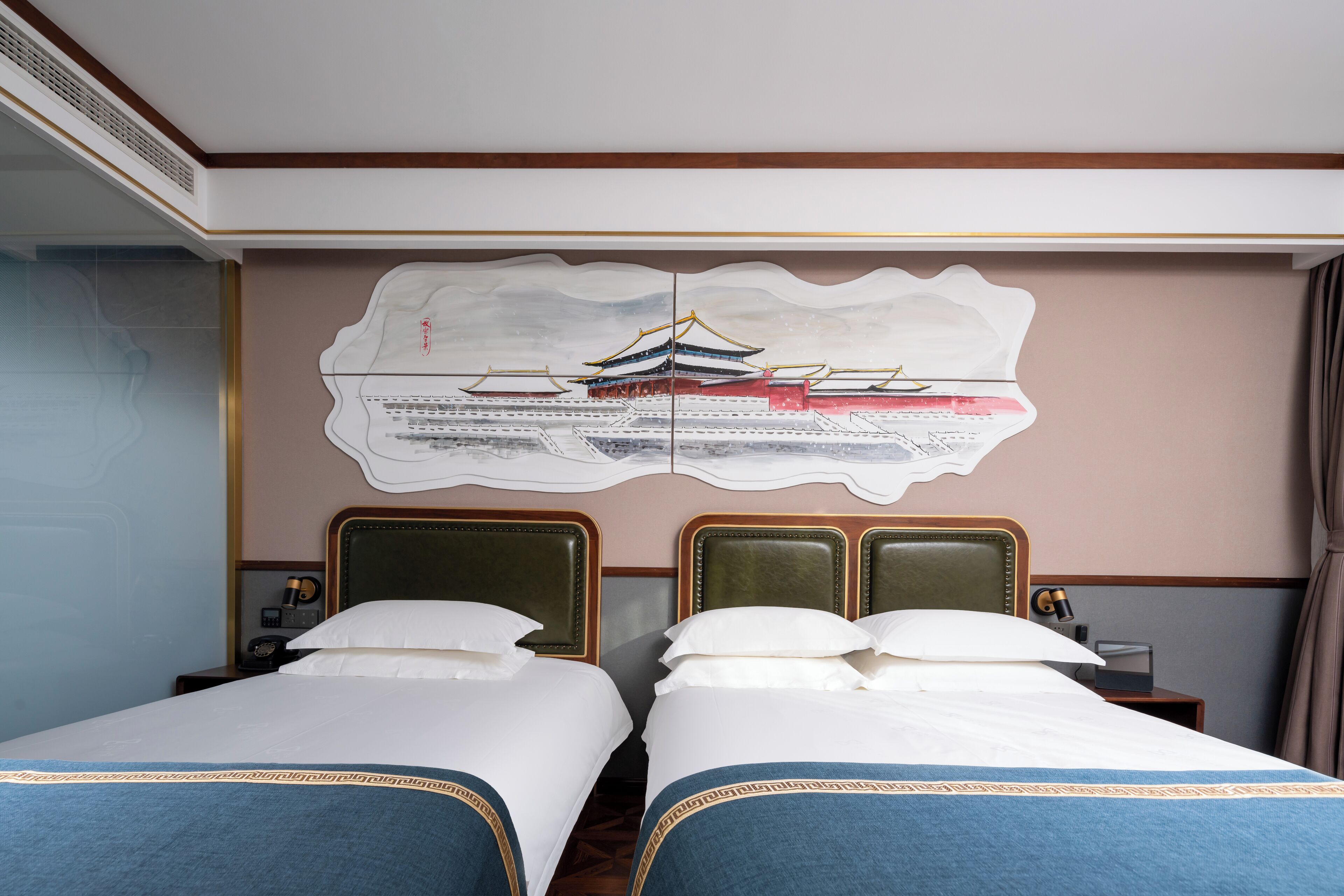 A hotel room with two beds, a large wall mural, and a wooden ceiling.