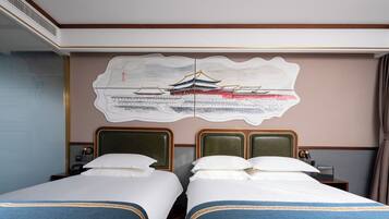 A hotel room with two beds, a large wall mural, and a wooden ceiling.