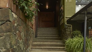 A staircase leading to a door with a number 790 sign above it. - The Somos Flats Provenza (Medellín)