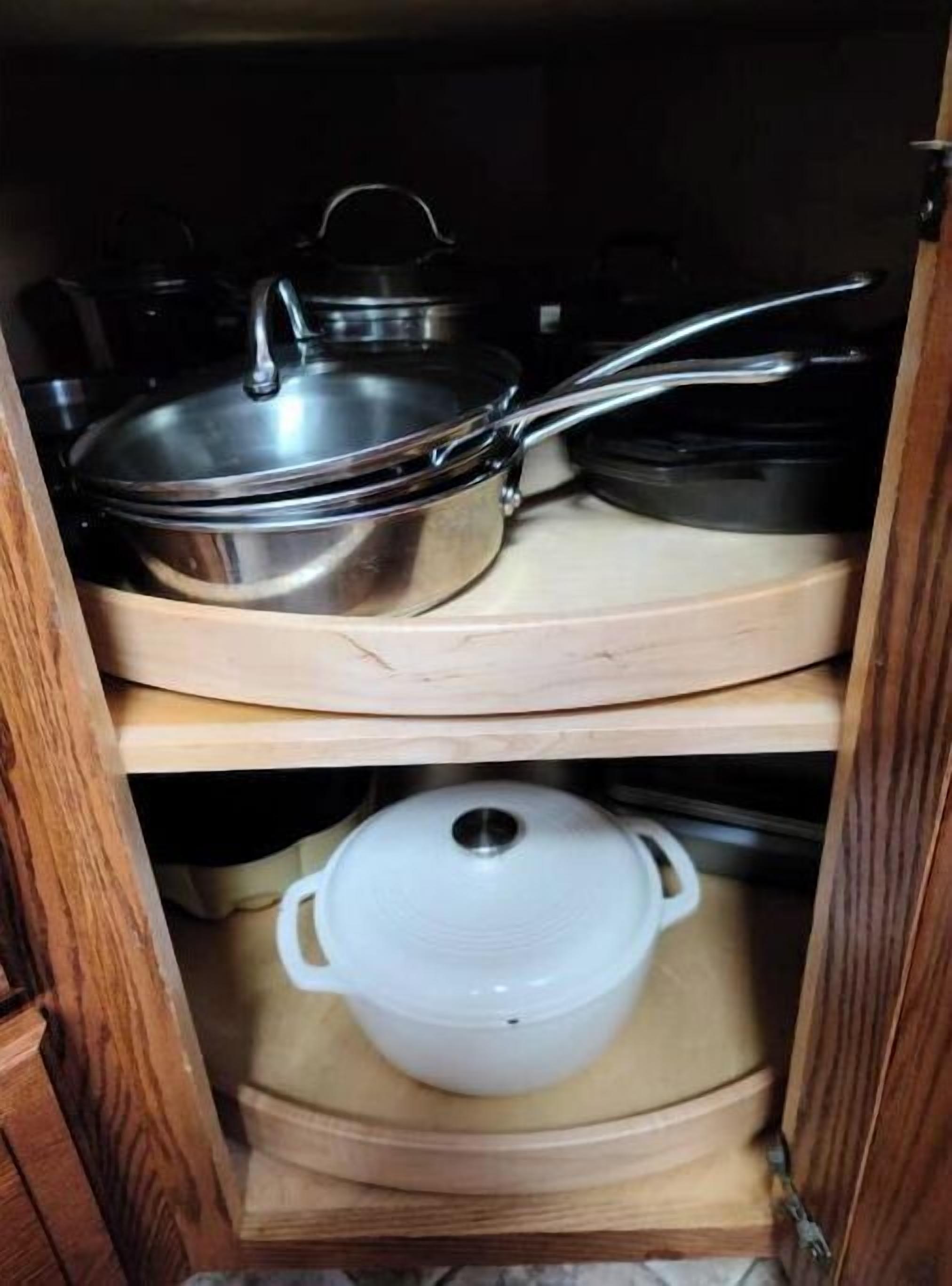 A wooden cabinet with two shelves, each holding a pot and a pan.