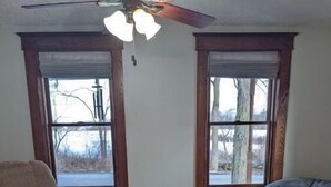 A living room with a wooden coffee table, a beige armchair, and a bean bag chair. - Your summer getaway- with a hot tub!

 (Millmont)