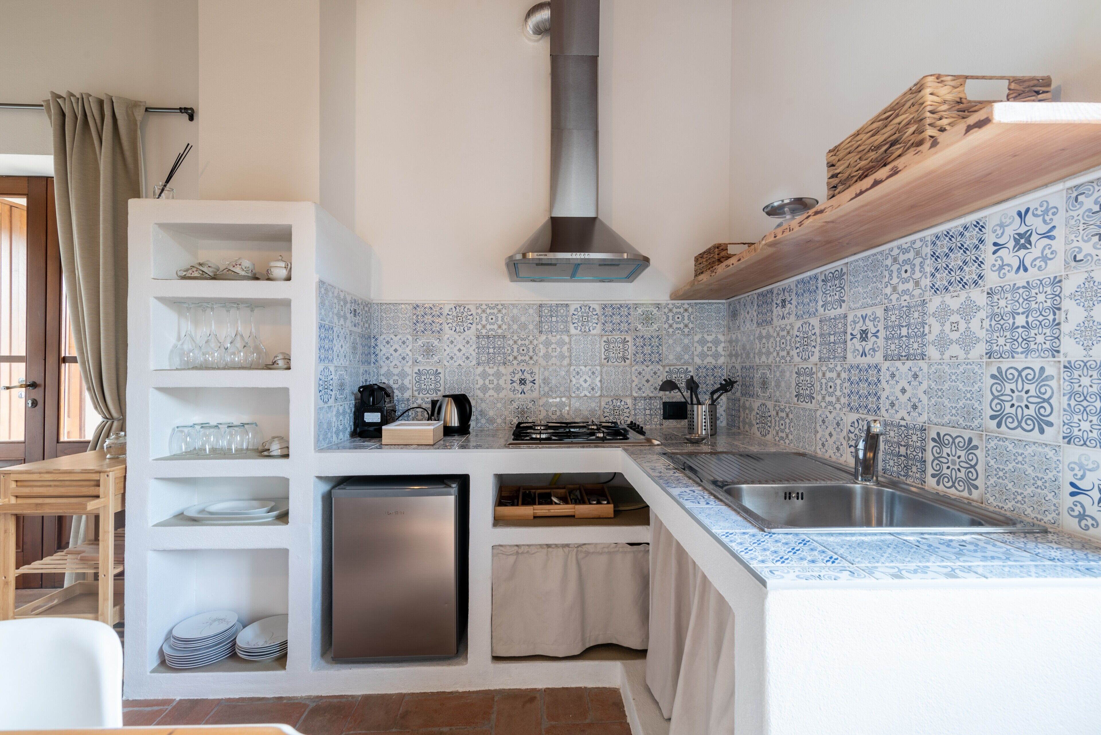 A compact kitchen with a built-in dishwasher, a gas stove, and a sink.