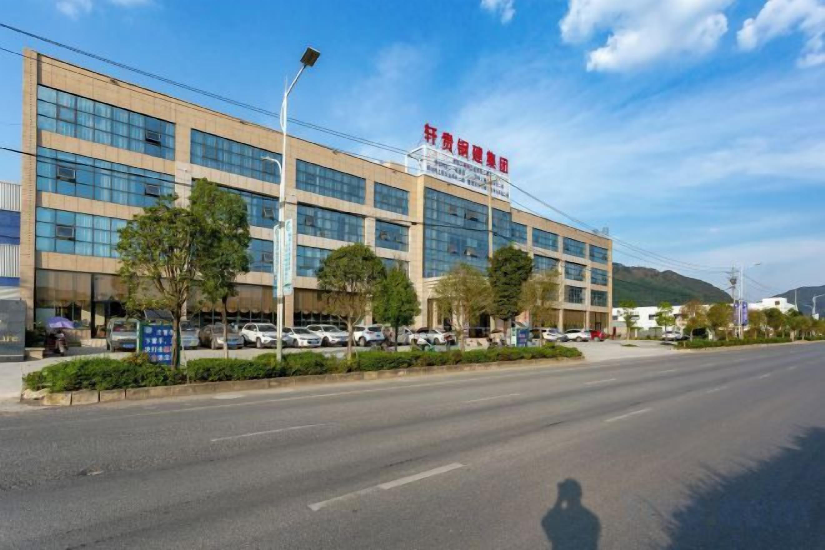 A multi-story building with a clear sky and a few trees in front.