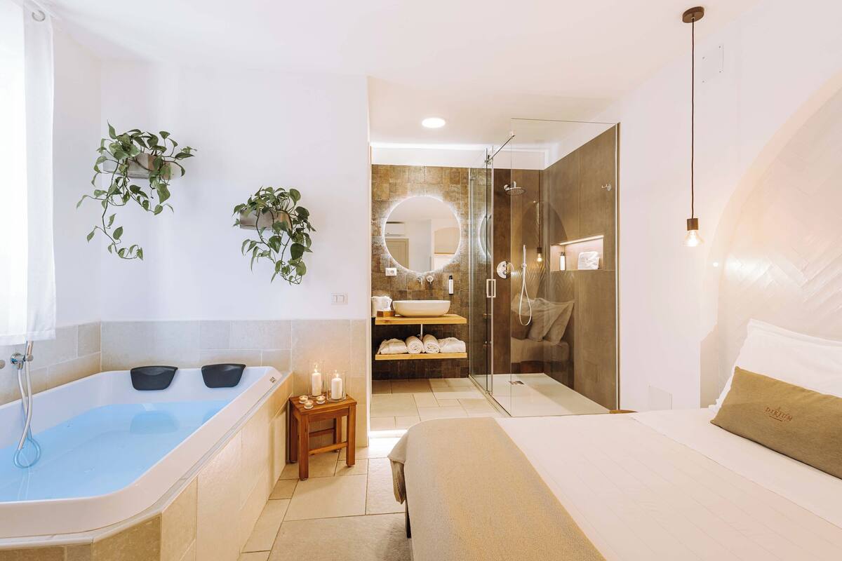 A modern bathroom with a bathtub, a shower, and a vanity with a mirror.