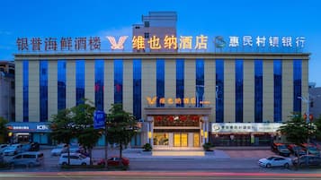 A multi-story building with a prominent sign at the top.
