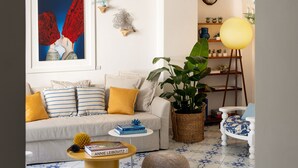 A living room with a sofa, coffee table, and potted plants. - Villa Michela, 2BR, 2BT, amazing patio, newly renovated (Capri)