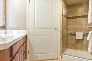 Bathroom features a shower area with a glass enclosure and a towel rack.