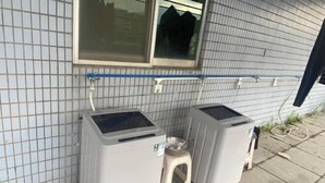 Two large, grey, industrial-style water heaters against a tiled wall with a window above. - Yaduo Hotel (Xinfeng County Yunjishan Scenic Area) (Xinfeng)