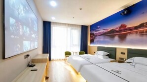 A hotel room with two beds, a desk, a projector screen, and a large wall mural. - Yaduo Hotel (Xinfeng County Yunjishan Scenic Area) (Xinfeng)