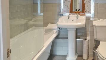 A bathroom with a bathtub, a sink, and a toilet.