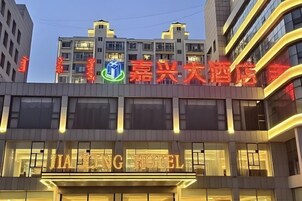 A hotel with a prominent sign and a modern building facade.