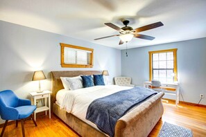 A bedroom with a bed, a chair, a desk, and a ceiling fan. - Cedar Creek Lakefront Vacation Rental w/ Pool (Gun Barrel City)