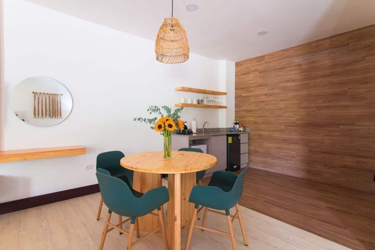 A modern kitchen with wooden cabinets, a built-in oven, and a sink.
