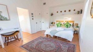 A bedroom with a bed, bedside tables, a desk, and a chair. - The Orange Door - Coastal Escape (Stuart)