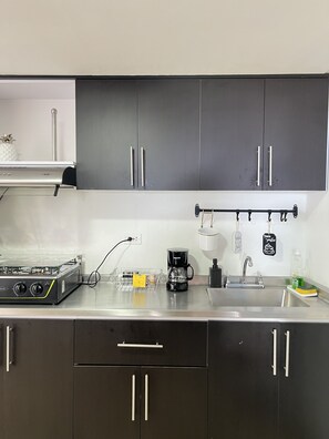 Fridge, microwave, stovetop, coffee/tea maker